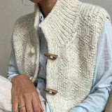 Cream textured sleeveless cardigan with five-button front and ribbed shawl collar