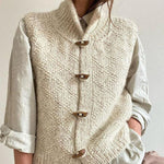 Cream chunky knit sleeveless cardigan vest with front button closure, shawl collar
