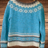 Blue knit pullover with geometric stripe hem and snowflake yoke, long sleeves