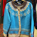 Blue knit pullover with geometric yoke, button-front placket, ribbed cuffs and hem