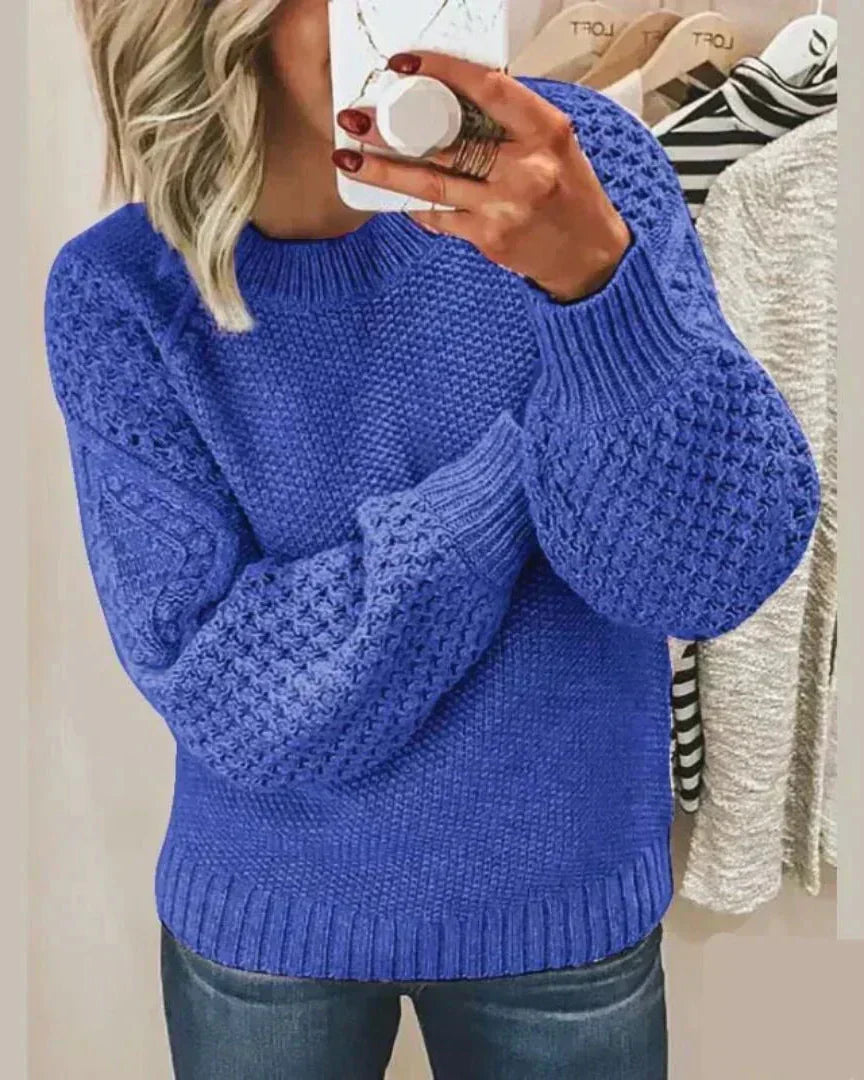 Blue chunky knit pullover with long sleeves and crew neck, textured stitch detail