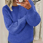 Blue chunky knit pullover with long sleeves and crew neck, textured stitch detail