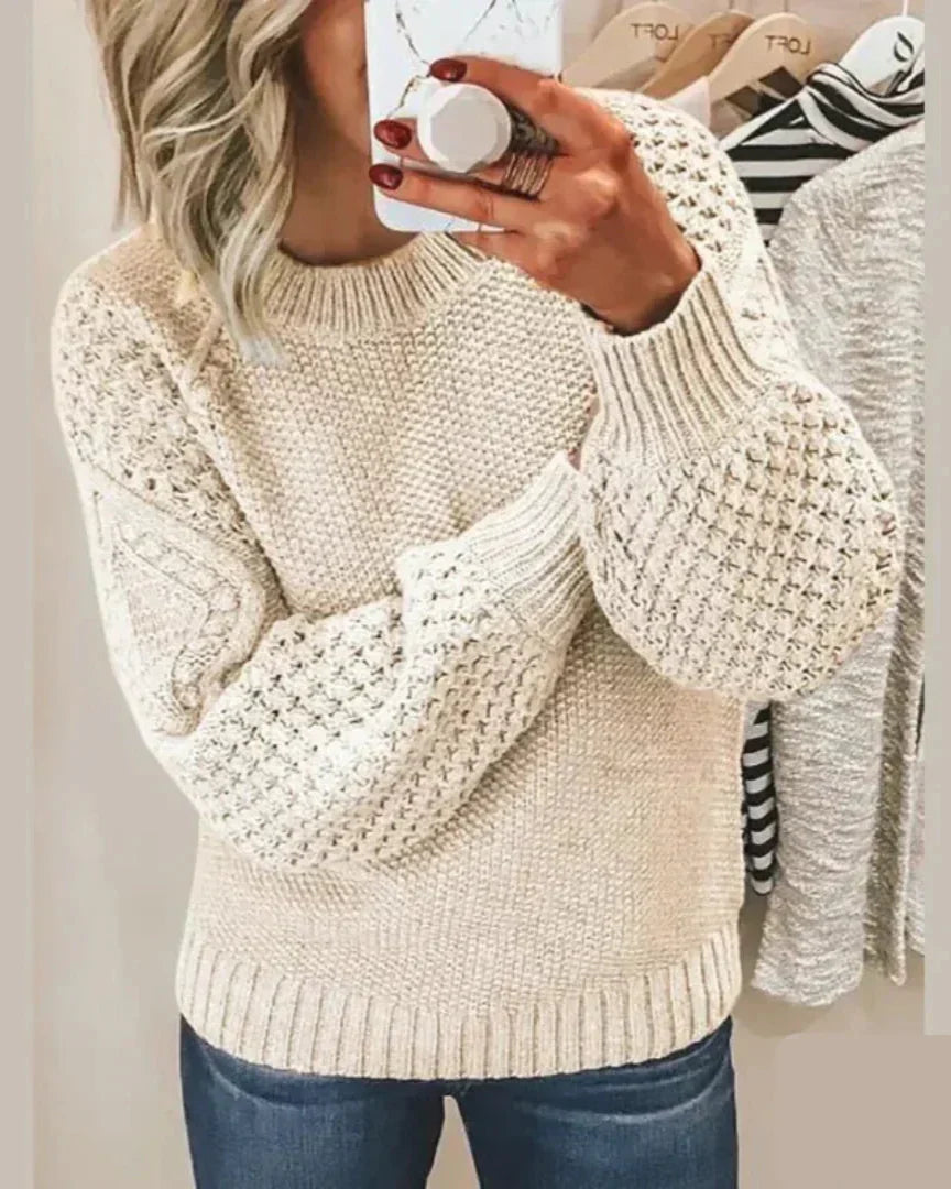 White chunky knit pullover with long sleeves and crew neck, textured stitch detail