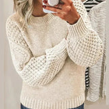 White chunky knit pullover with long sleeves and crew neck, textured stitch detail