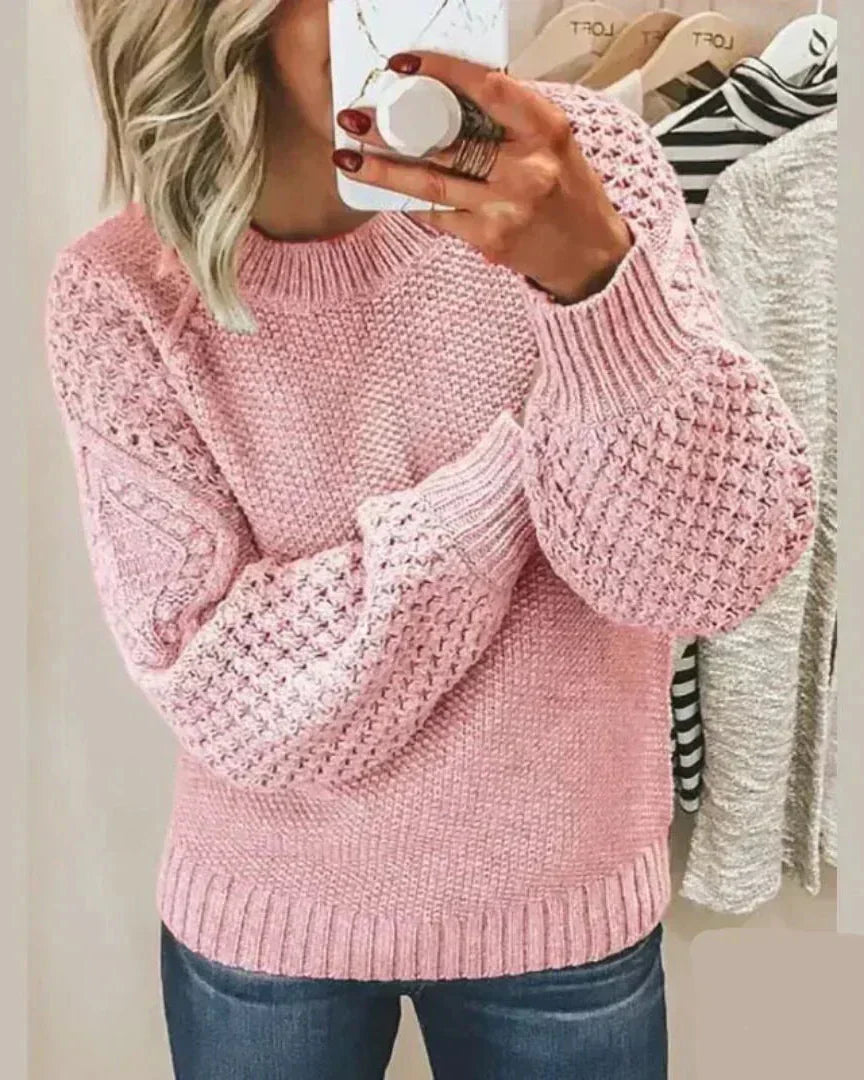 Pink chunky knit pullover with long sleeves and crew neck, textured stitch detail
