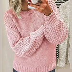 Pink chunky knit pullover with long sleeves and crew neck, textured stitch detail