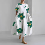 Women's floral dress, white base with green clover and gold flower print, midi length