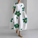 Women's floral dress, white base with green clover and gold flower print, midi length