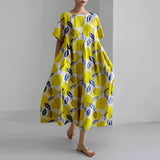Women's floral dress, bright yellow base with navy and white leaf print, midi length