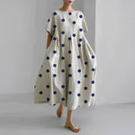 Women's floral dress, white base with navy polka dots print, midi length, short sleeves