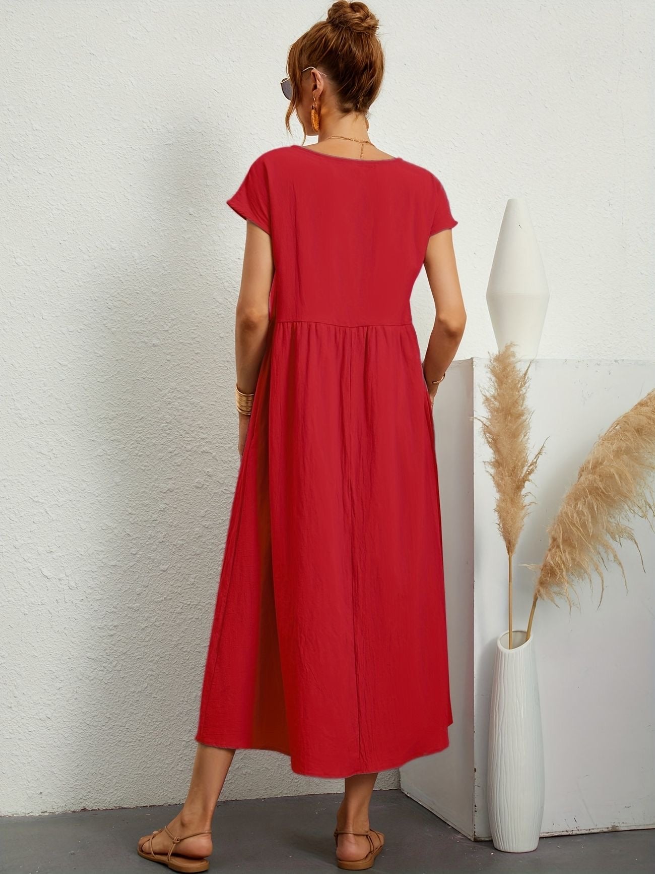 Red midi casual dress from back view with short sleeves and gathered waist, flared skirt