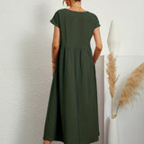 Dark green midi casual dress with short sleeves and gathered waist, back view