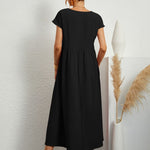 Black midi casual dress from back view with short sleeves and gathered waist, flared skirt