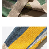 Beige crew pullover side closeup with striped knit panel and ribbed cuff