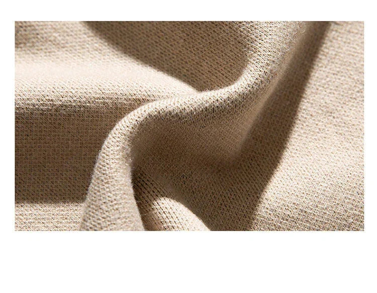 Beige crew pullover fabric closeup showing textured knit weave