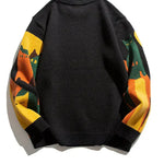 Black crew pullover with solid back and multicolor striped sleeves, ribbed hem