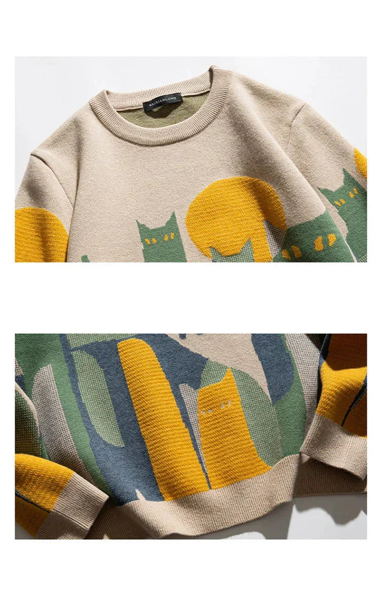 Beige knit crew pullover closeup with cat graphic and ribbed cuffs