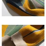 Beige crew pullover sleeve closeup with multicolor striped knit and ribbed cuff