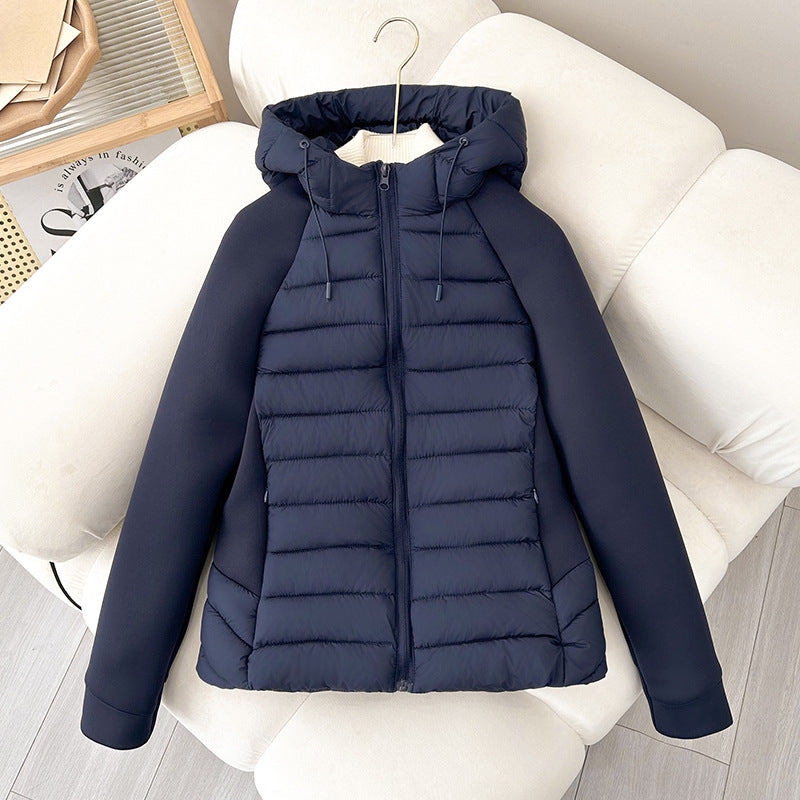 Women’s light hybrid quilted jacket with hood, navy, zip-up front on chair