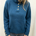 Blue knit long-sleeve pullover with button placket at the neckline and ribbed cuffs