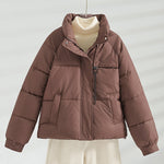 Brown short quilted jacket with stand collar, front zipper, and two chest pockets