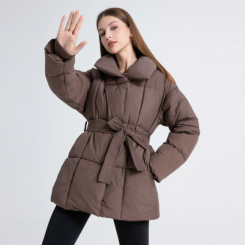 Women's tailored quilted puffer coat in dark brown with tie belt and high shawl collar