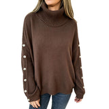 Oversized dark brown knit turtleneck pullover with buttoned cuffs, long sleeves
