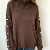 Oversized brown knit turtleneck pullover with buttoned cuffs and long sleeves