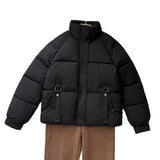 Black short quilted puffer jacket with stand collar and zip front, D-ring strap pockets