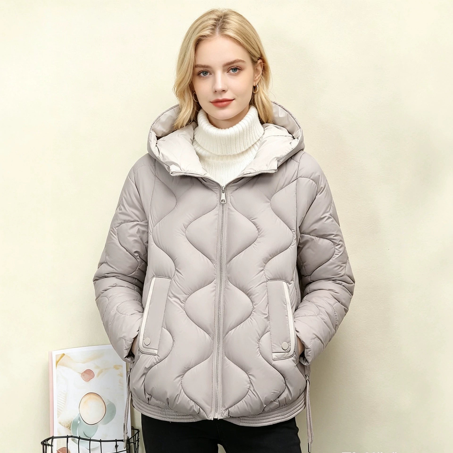 Light gray quilted short jacket with hood, heart stitching, zip front and pocket flaps.