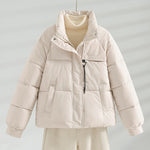 Cream short quilted jacket with stand collar, front zipper, and two flap pockets