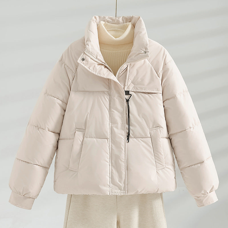 Cream short quilted jacket with stand collar, front zipper, and two flap pockets