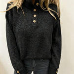 Black knit long-sleeve pullover with button placket, stand collar and ribbed hem