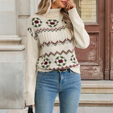 Cream knit turtleneck sweater with fair isle reindeer pattern, ribbed cuffs and hem