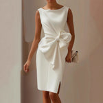 White satin sleeveless dress with draped waist and oversized bow