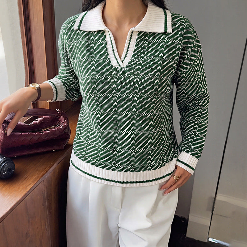 Green V-neck sweater with textured knit pattern and white ribbed collar and cuffs.