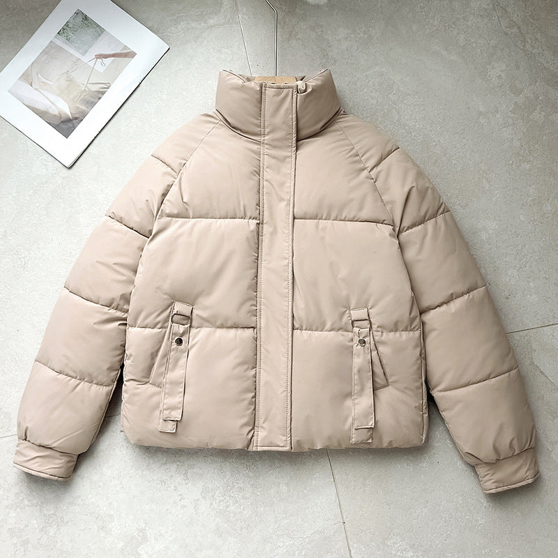 Light beige short quilted puffer jacket with high stand collar, zip front, D-ring strap pockets
