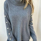 Oversized blue-gray long-sleeve turtleneck sweater with buttoned sleeve cuffs
