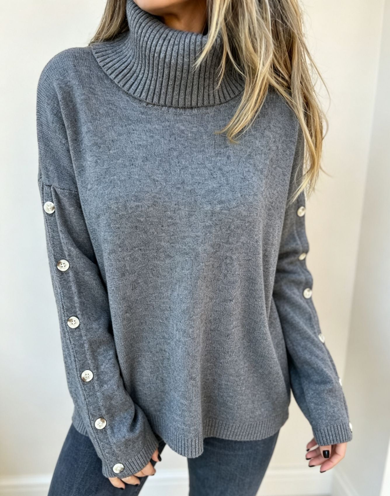 Oversized blue-gray long-sleeve turtleneck sweater with buttoned sleeve cuffs