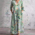 Floral long dress in mint green with V-neck and three-quarter sleeves, gathered waist