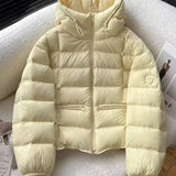 Short padded hooded thermal jacket in pale yellow with full-zip front and side zip pockets