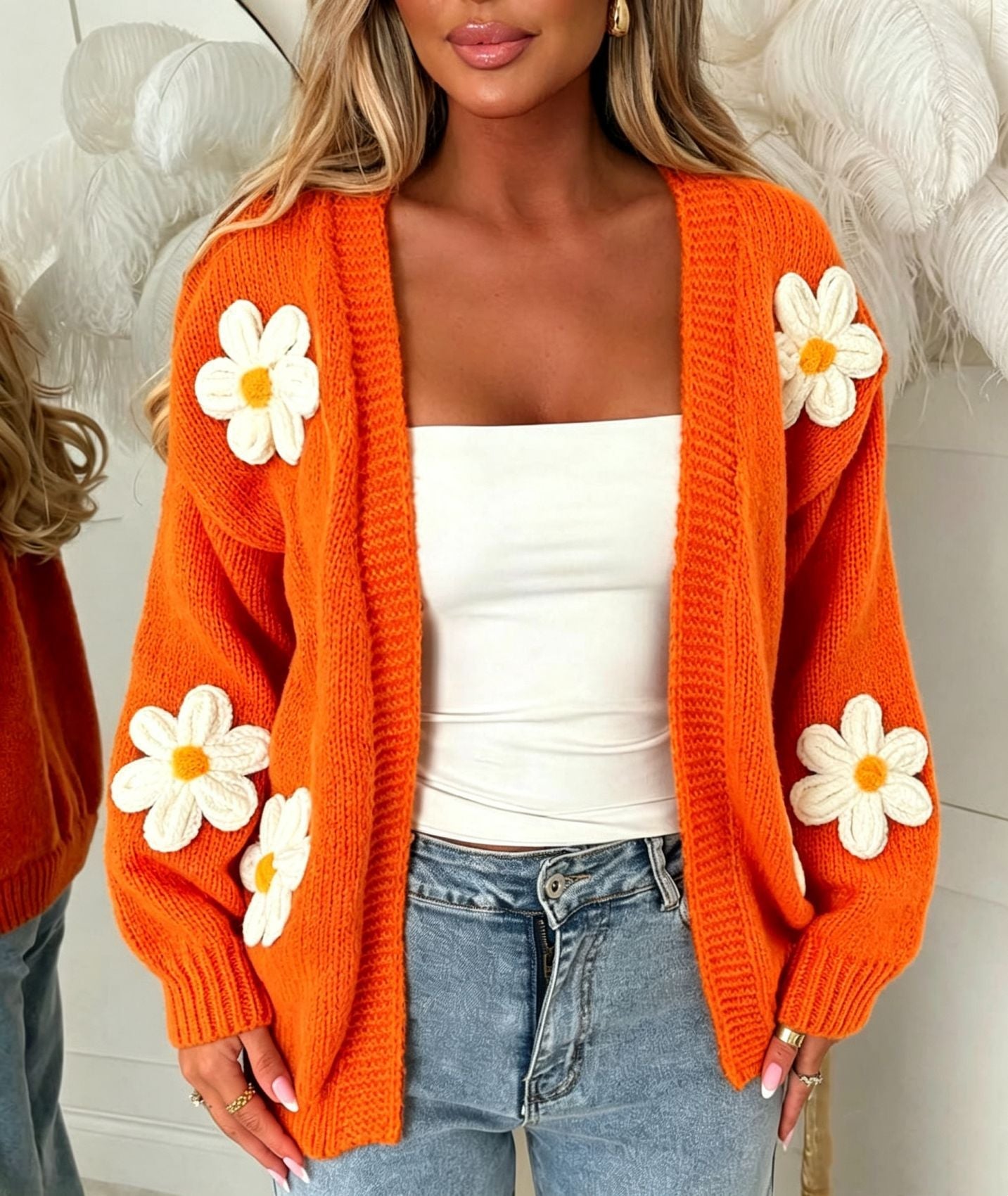 Orange oversized long-sleeve cardigan with white flower appliqués and open front