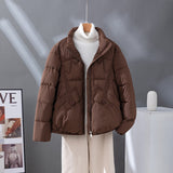 Women's short quilted jacket in brown, high collar, zip front, flap pockets.