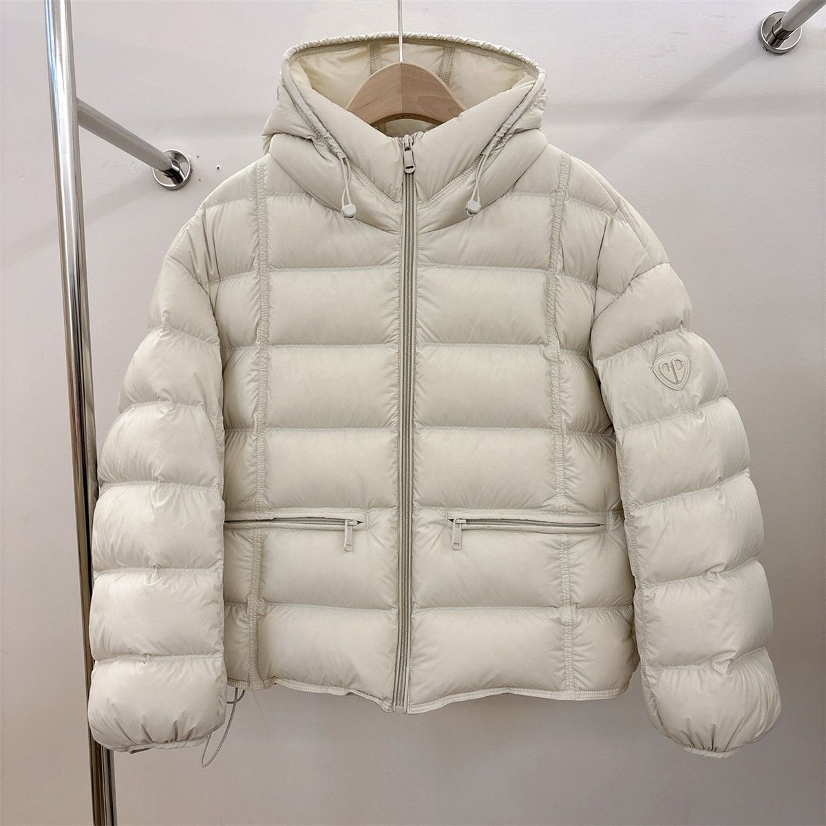 Short padded hooded thermal jacket in off-white with full-zip front and side zip pockets