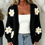 Oversized black long-sleeve cardigan with daisy appliqués