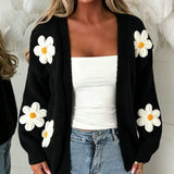 Oversized black long-sleeve cardigan with daisy appliqués