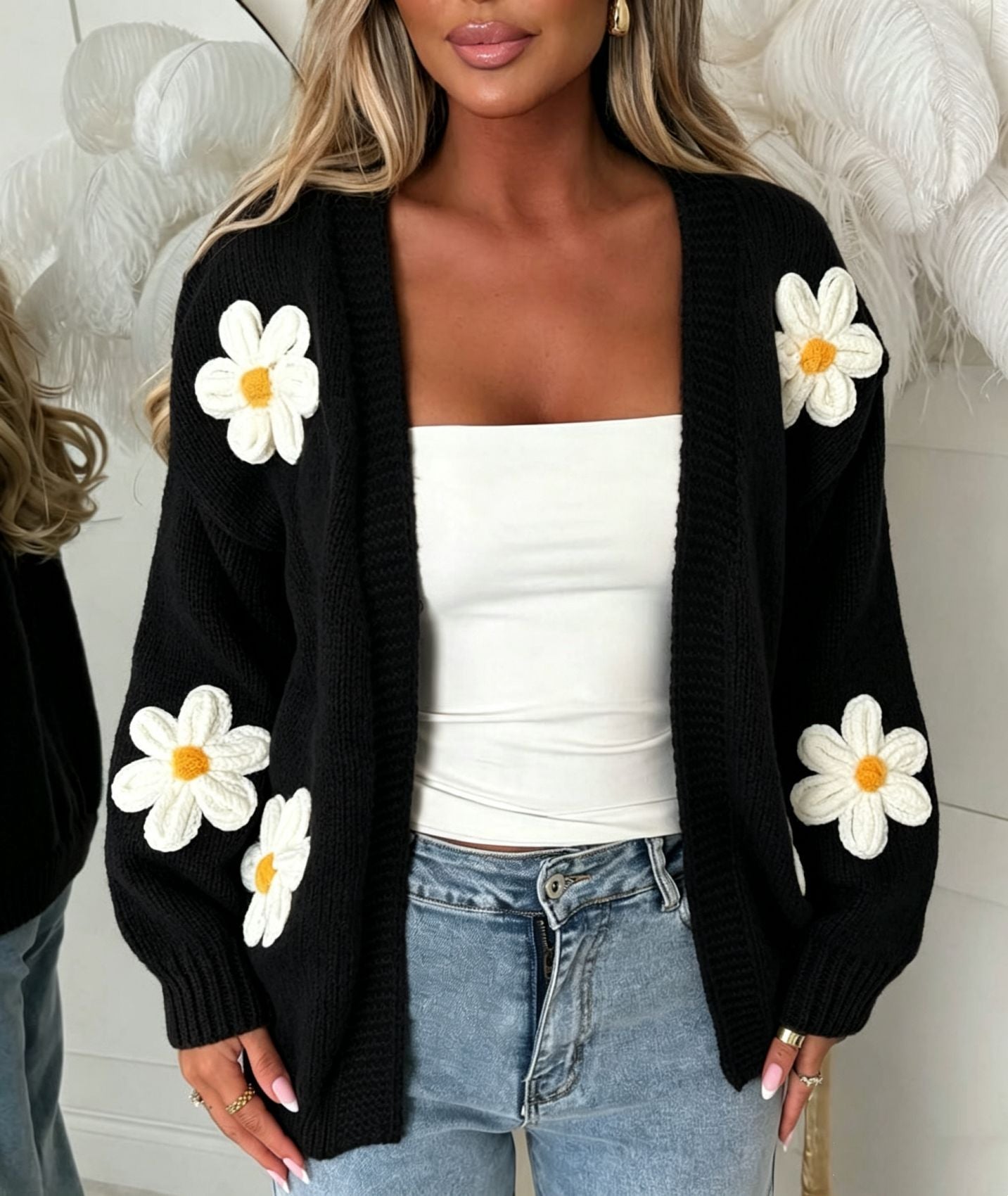 Oversized black long-sleeve cardigan with daisy appliqués