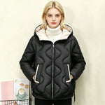 Black quilted short jacket with hood, heart stitching, full zip front and side pockets.