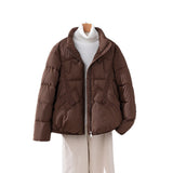 Women's short quilted jacket in brown, high collar, zip front, flap pockets.