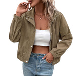 Cropped long-sleeve beige jacket with zipper-like trim, snap buttons, and side pockets.